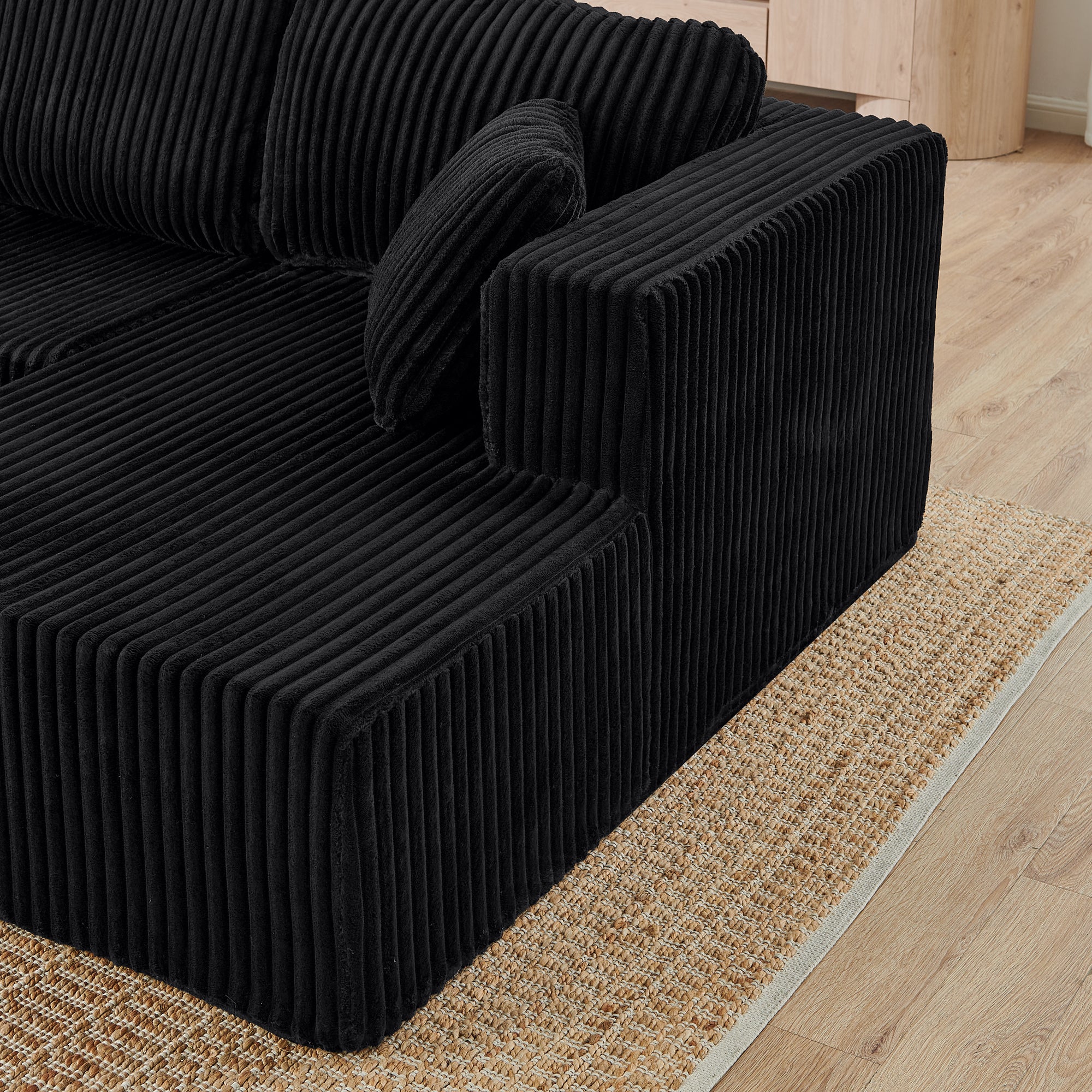Black corduroy modular sectional sofa, corner configuration view