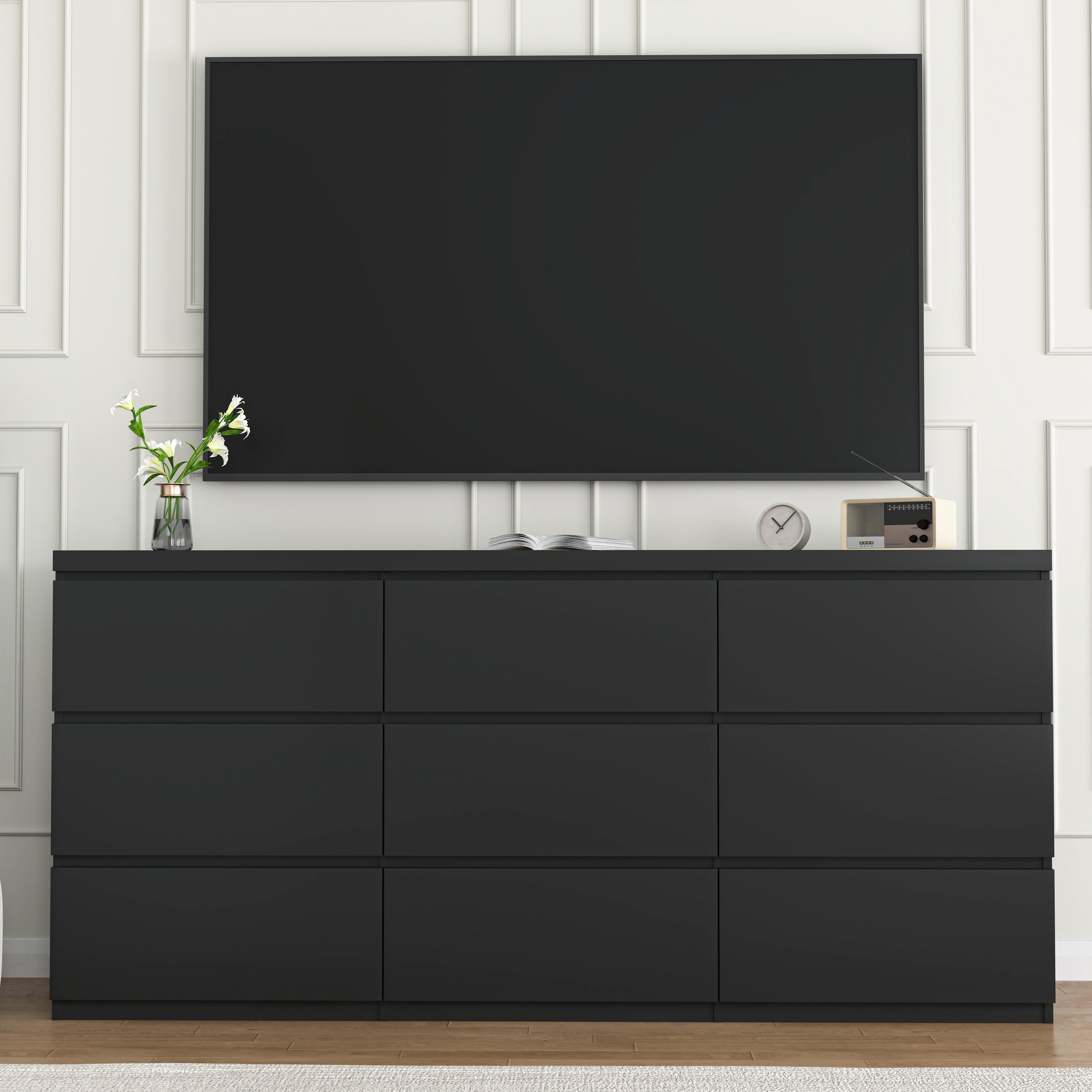 Modern black matte wood dresser styled in bedroom setting