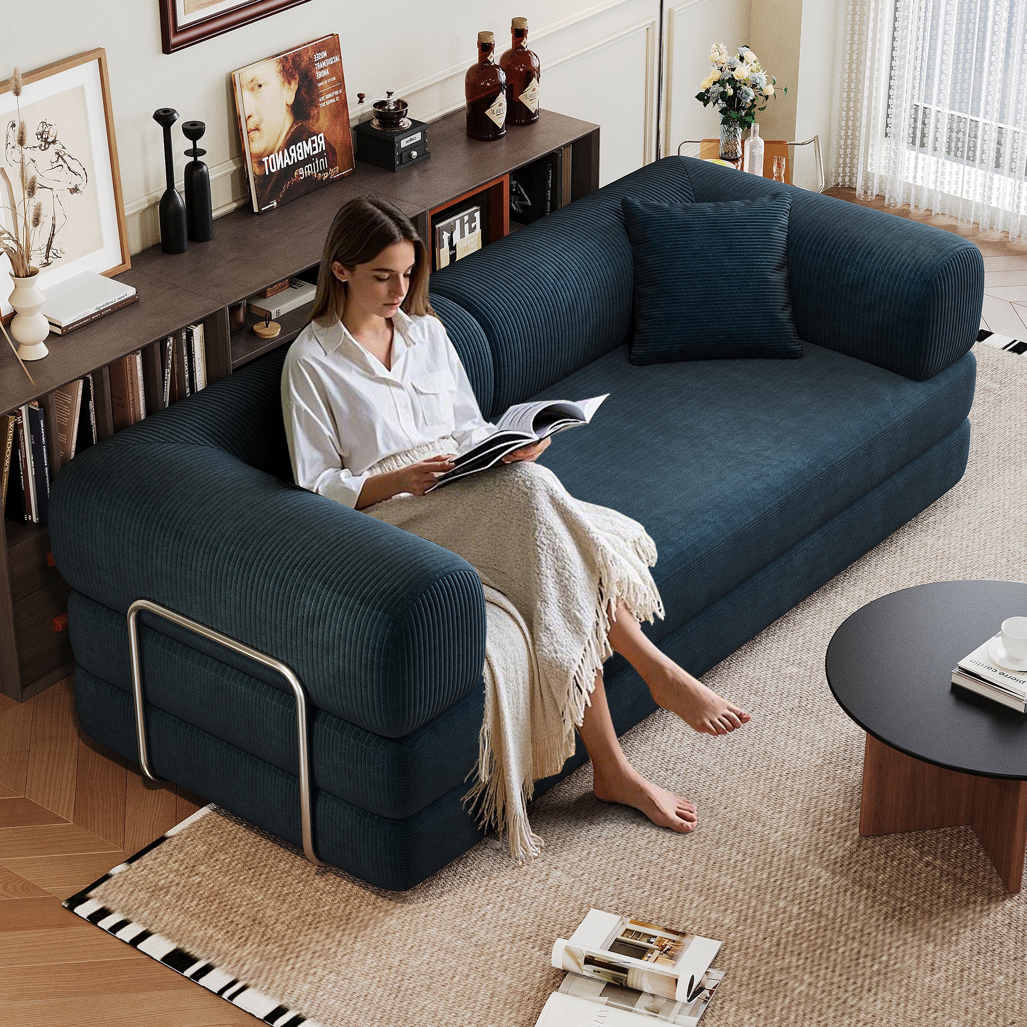 Blue corduroy convertible sofa bed in living room setting