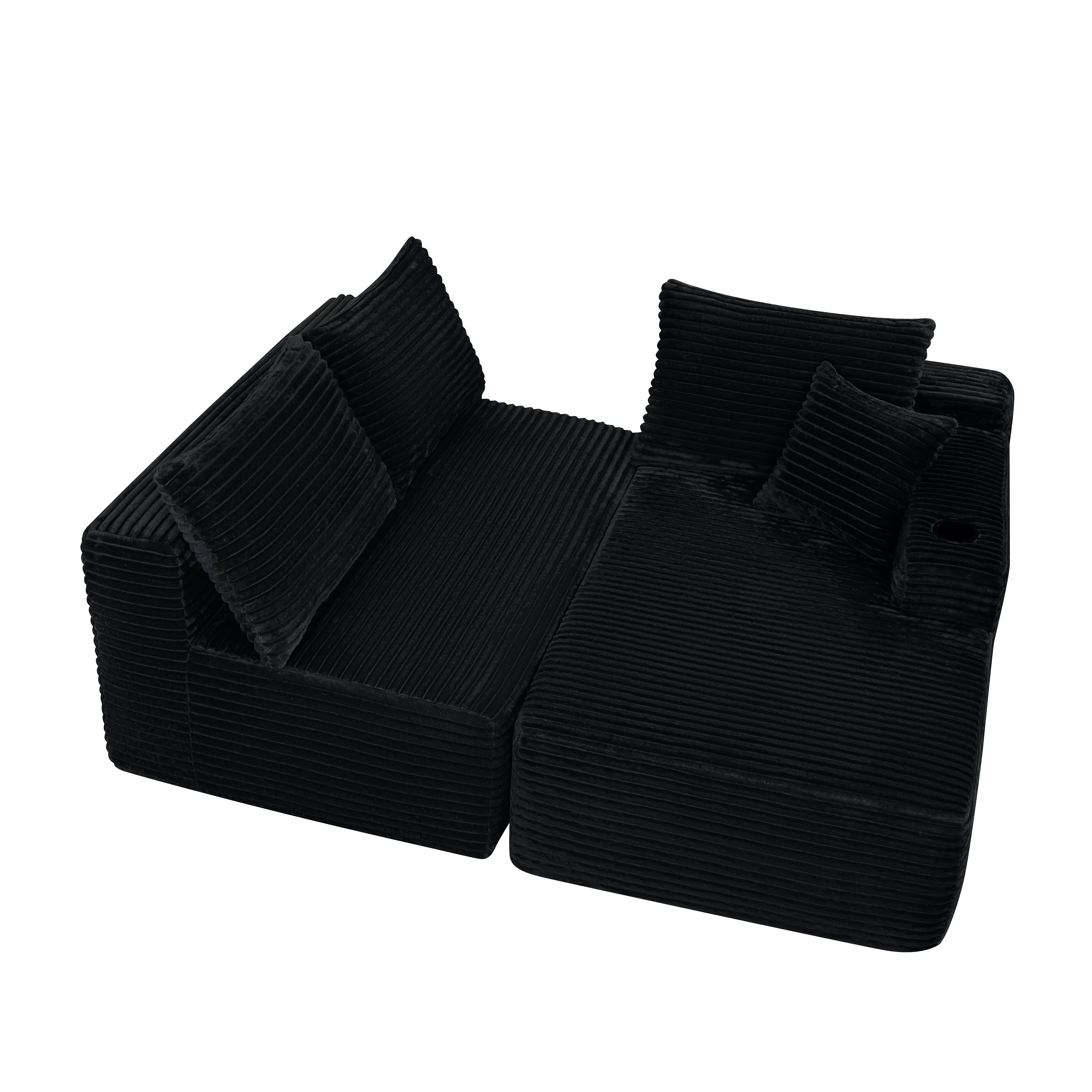 Black deep-seat modular sectional sofa with built-in cup holder, close-up