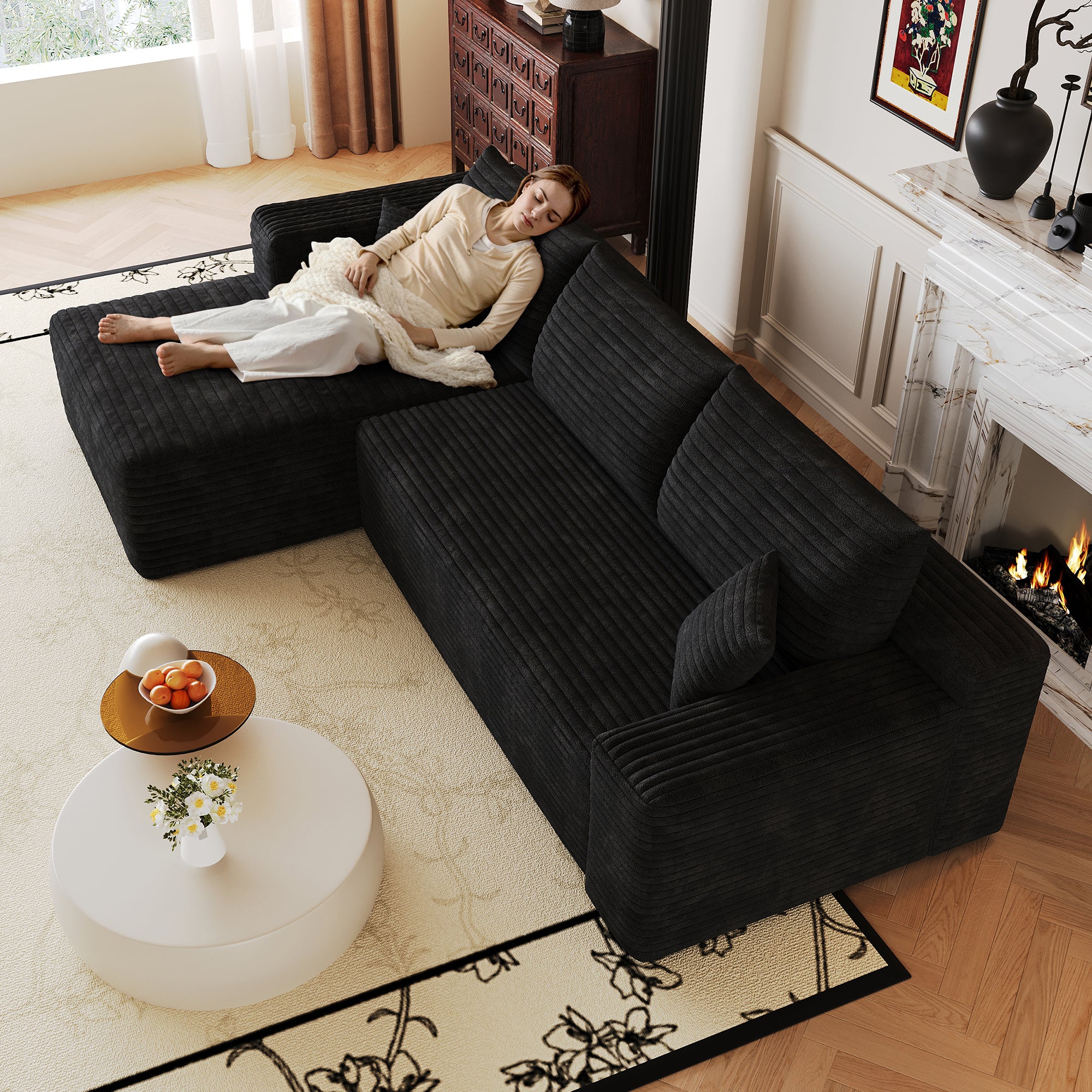 Black corduroy sectional sofa, plush fabric texture close-up
