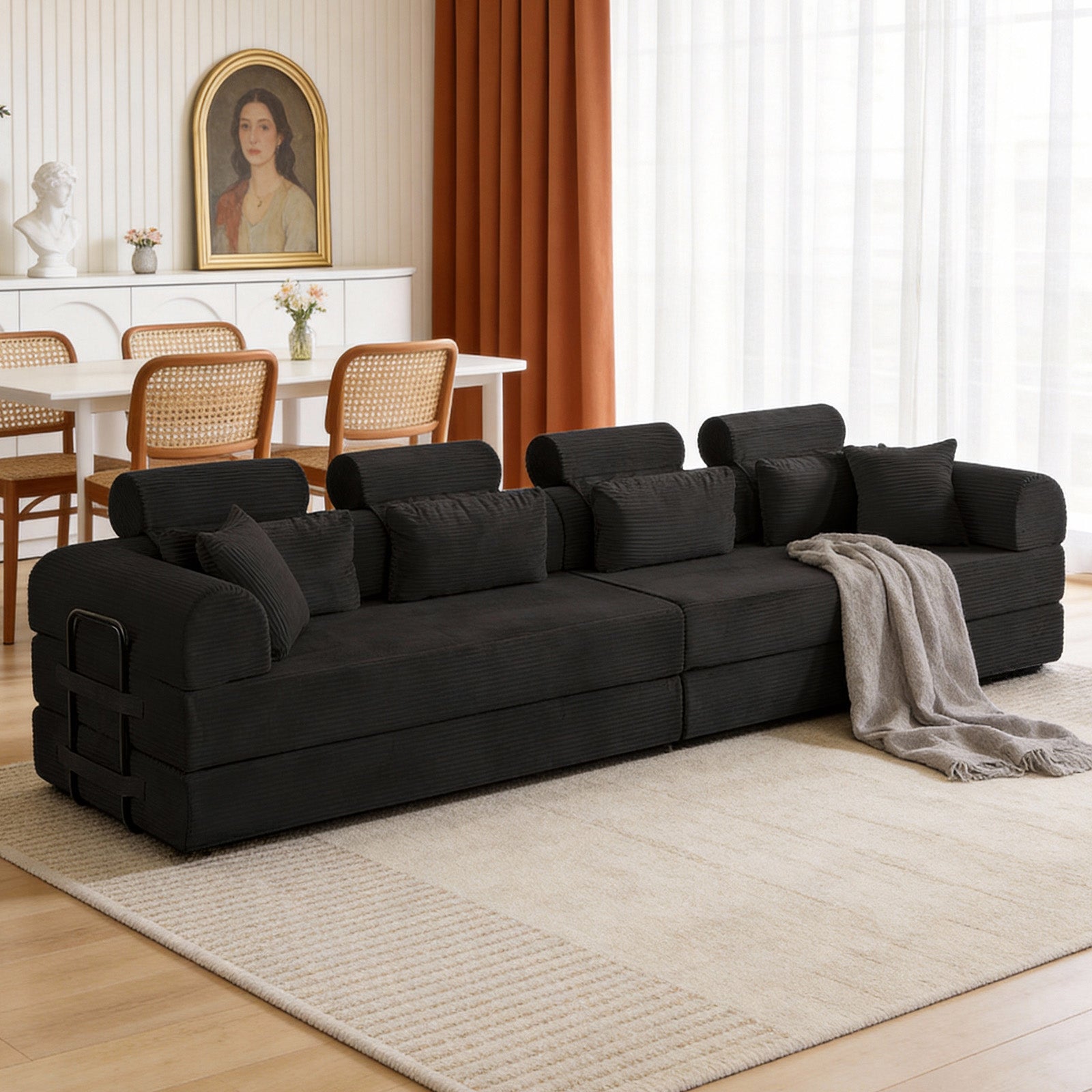 Black corduroy modular sofa unfolded into a bed, side view