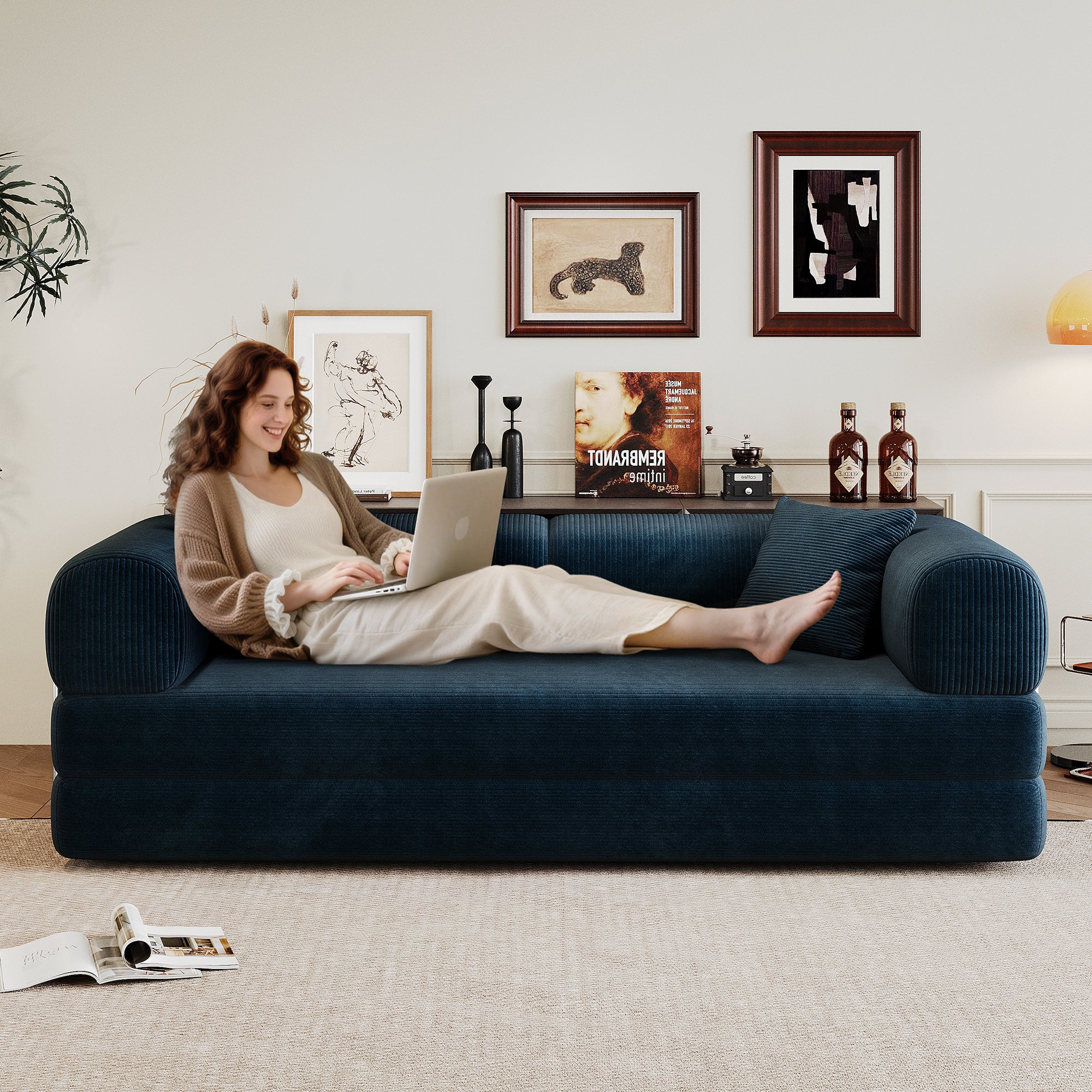 Blue corduroy modular sectional sofa with back pillow and armrest, side view