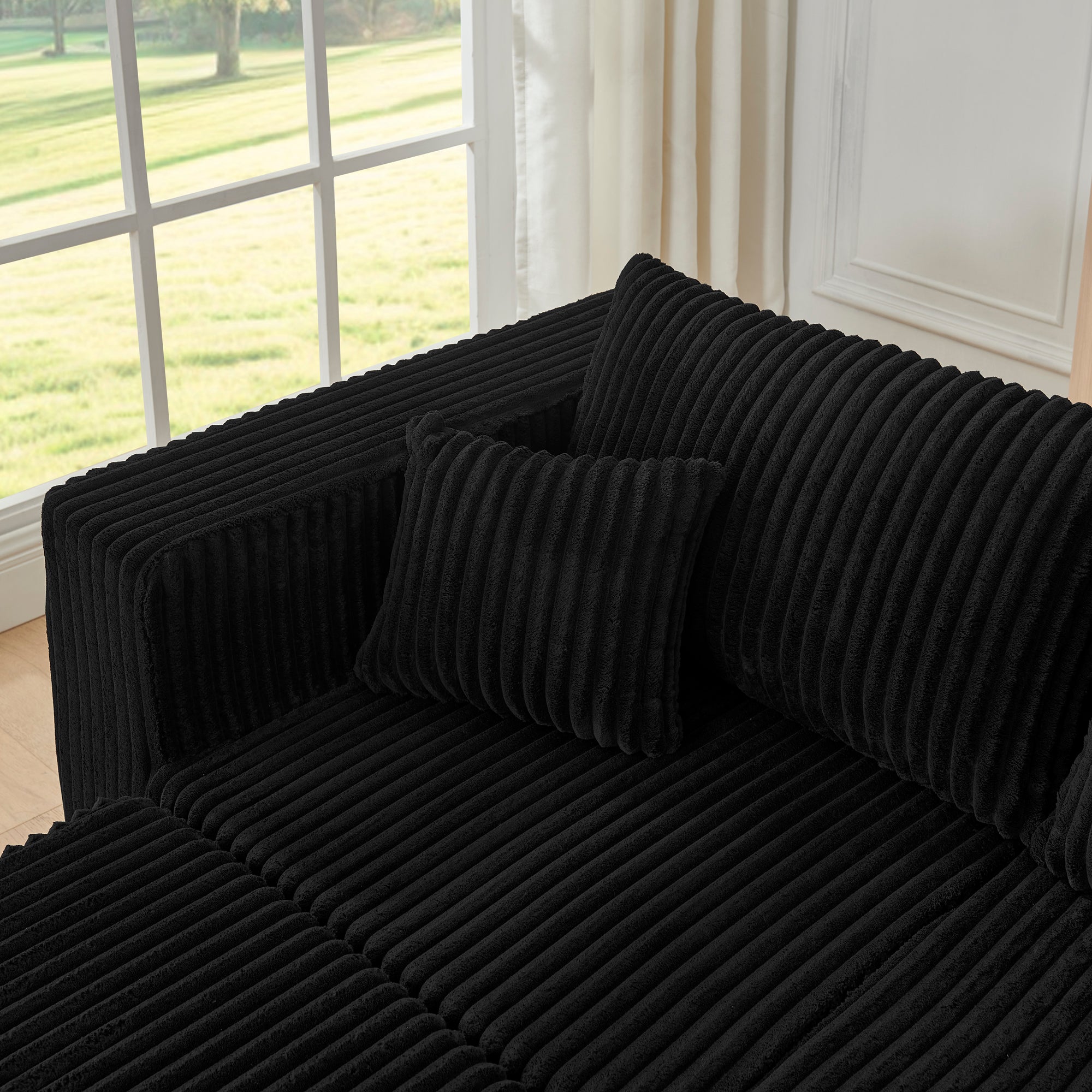 Modern minimalist black corduroy modular sofa, cushion texture close-up