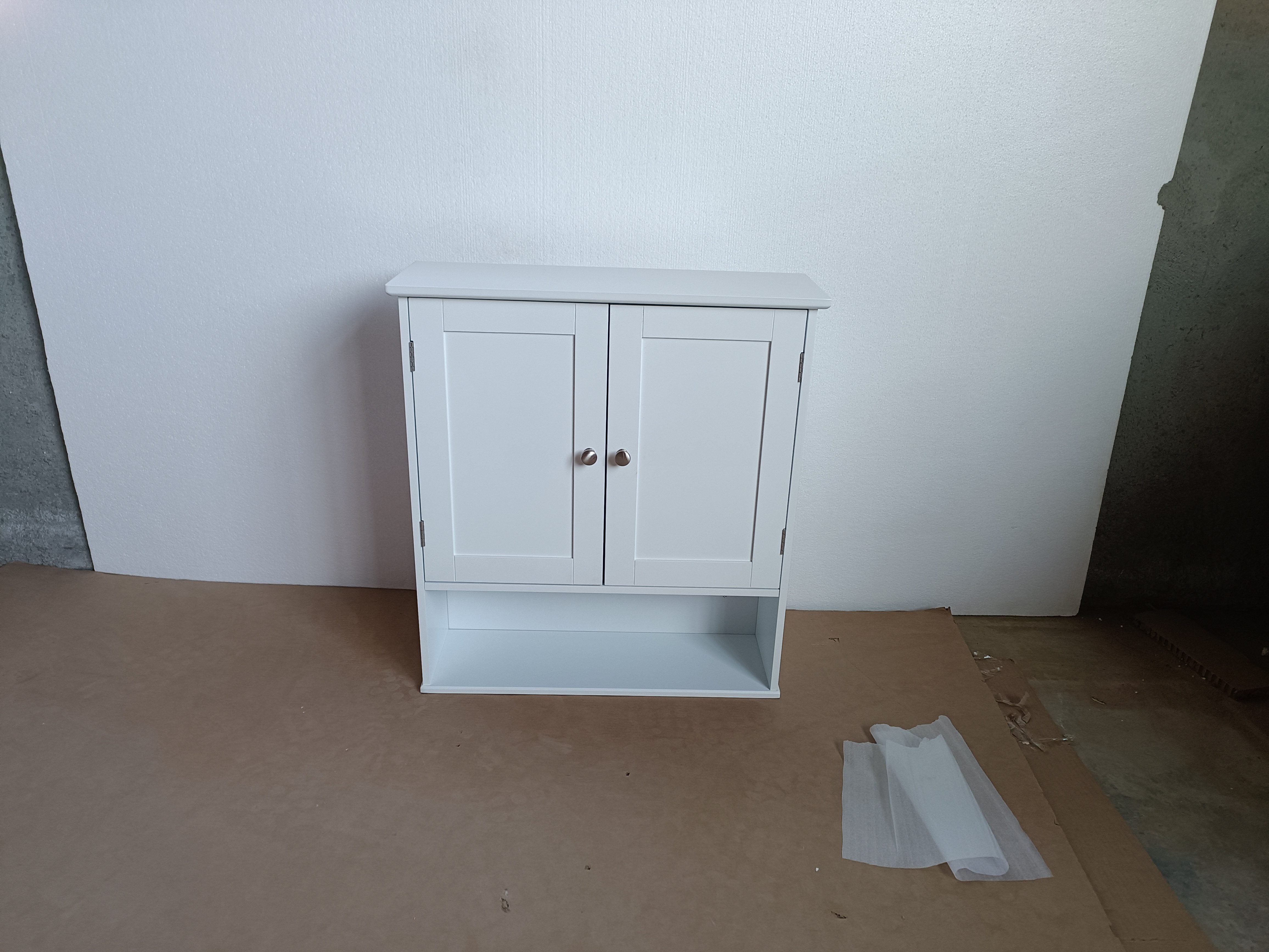 White wall-mounted bathroom storage cabinet, side profile view