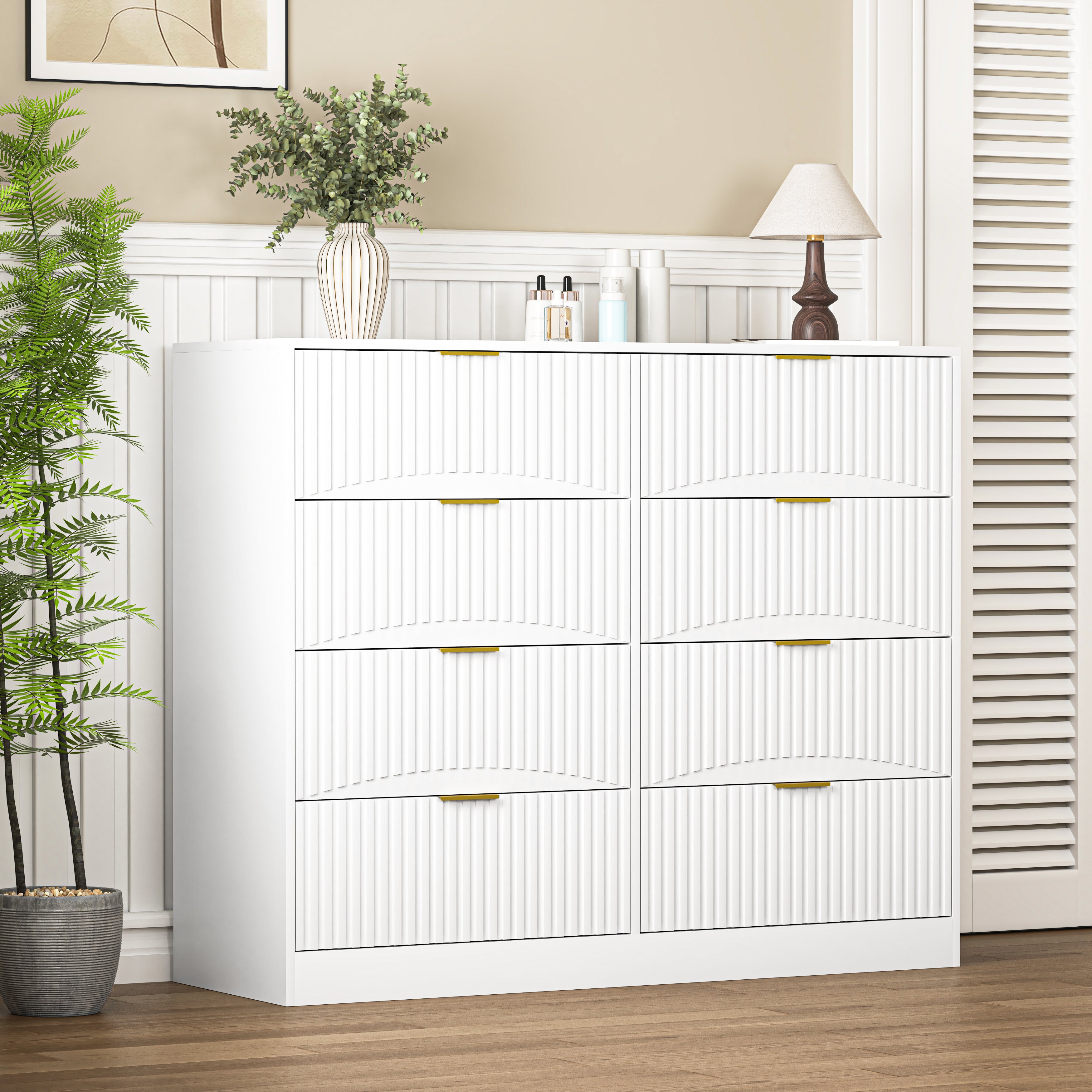 White 8-drawer dresser in bedroom setting, styled view