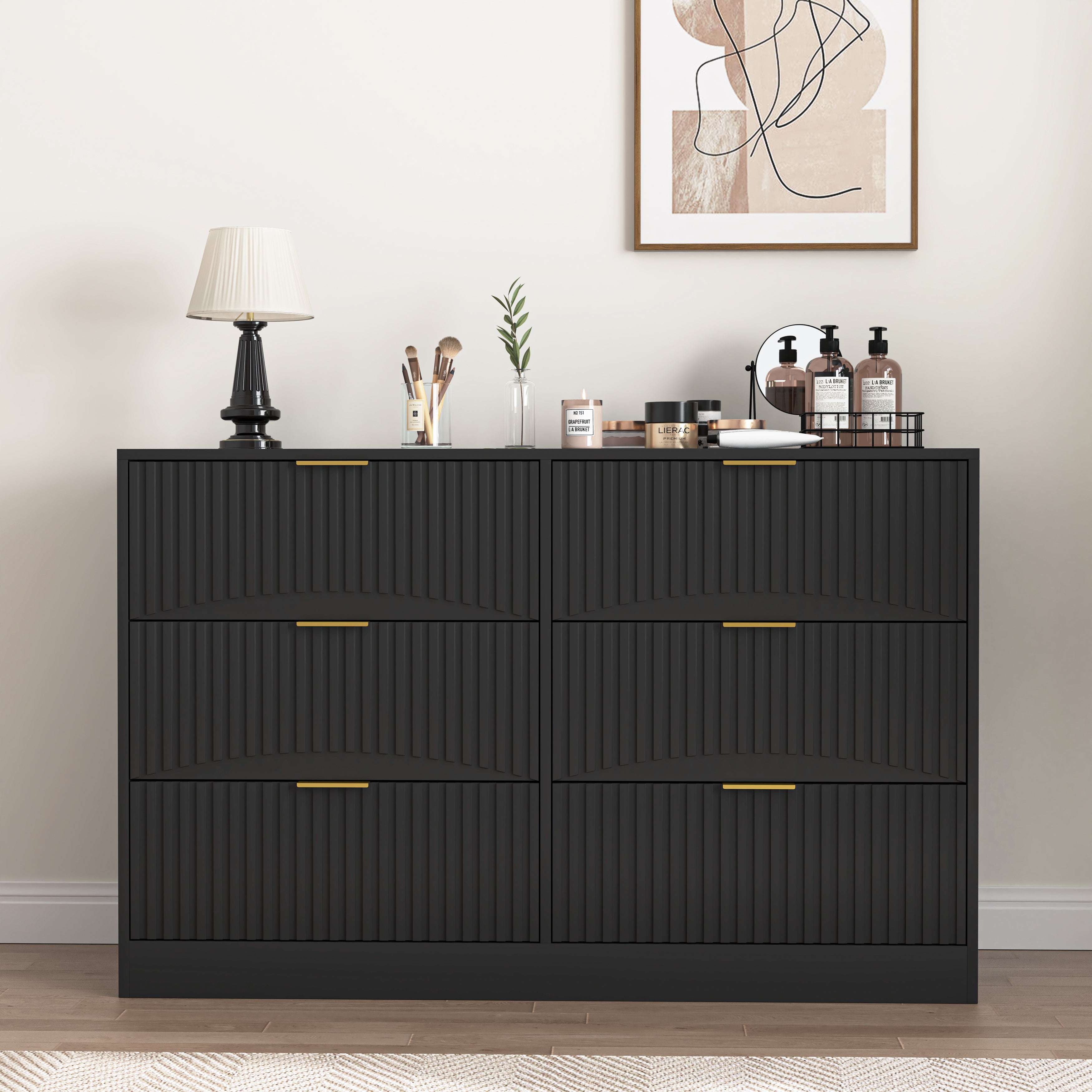 Modern black dresser styled in a bedroom setting