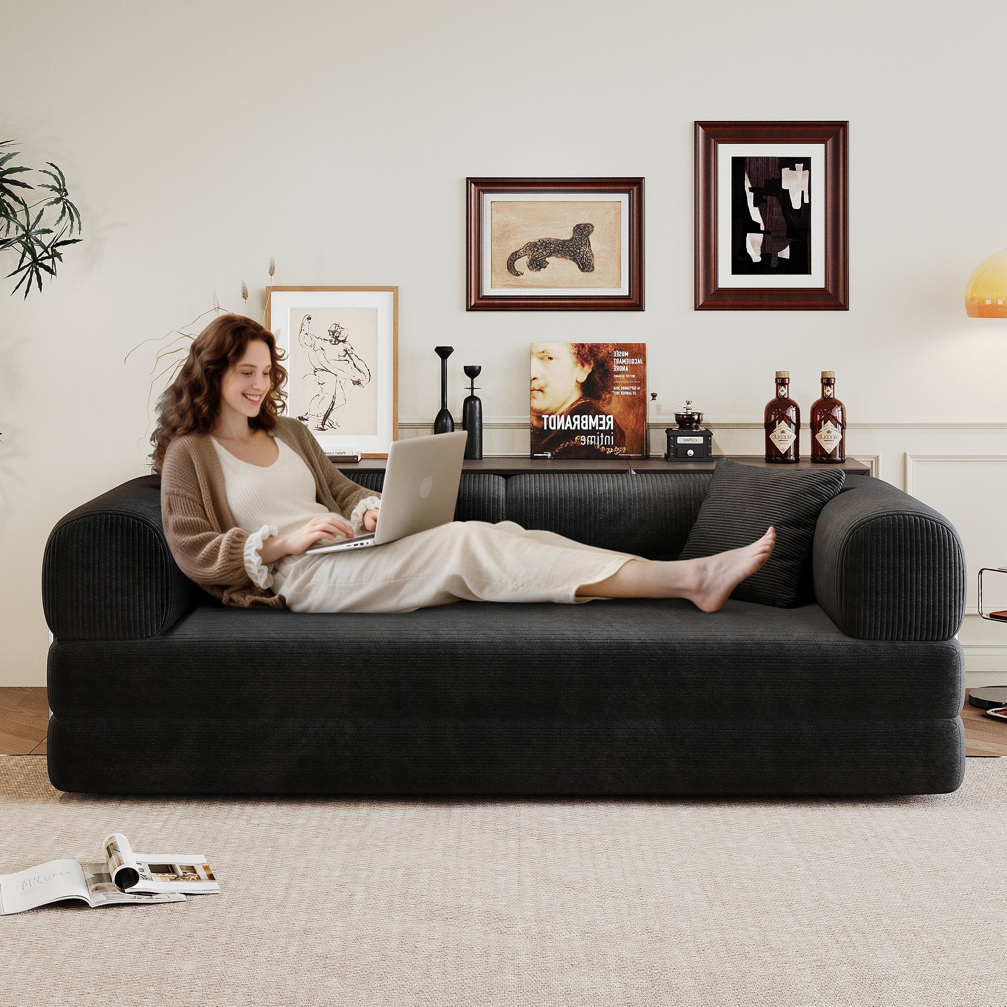 Black corduroy convertible sofa bed with armrest, detail view