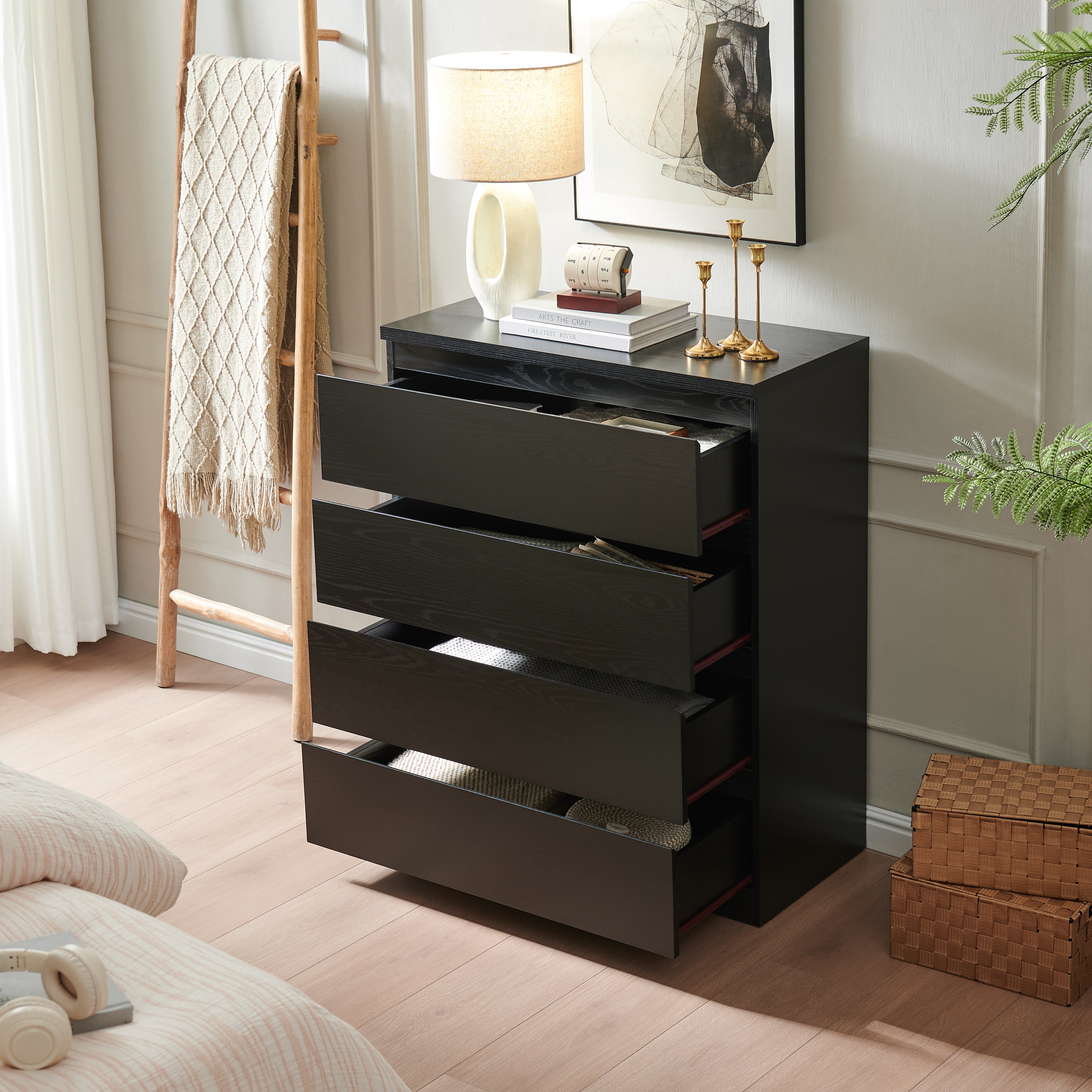 Black modern 4-drawer chest of drawers, angled view