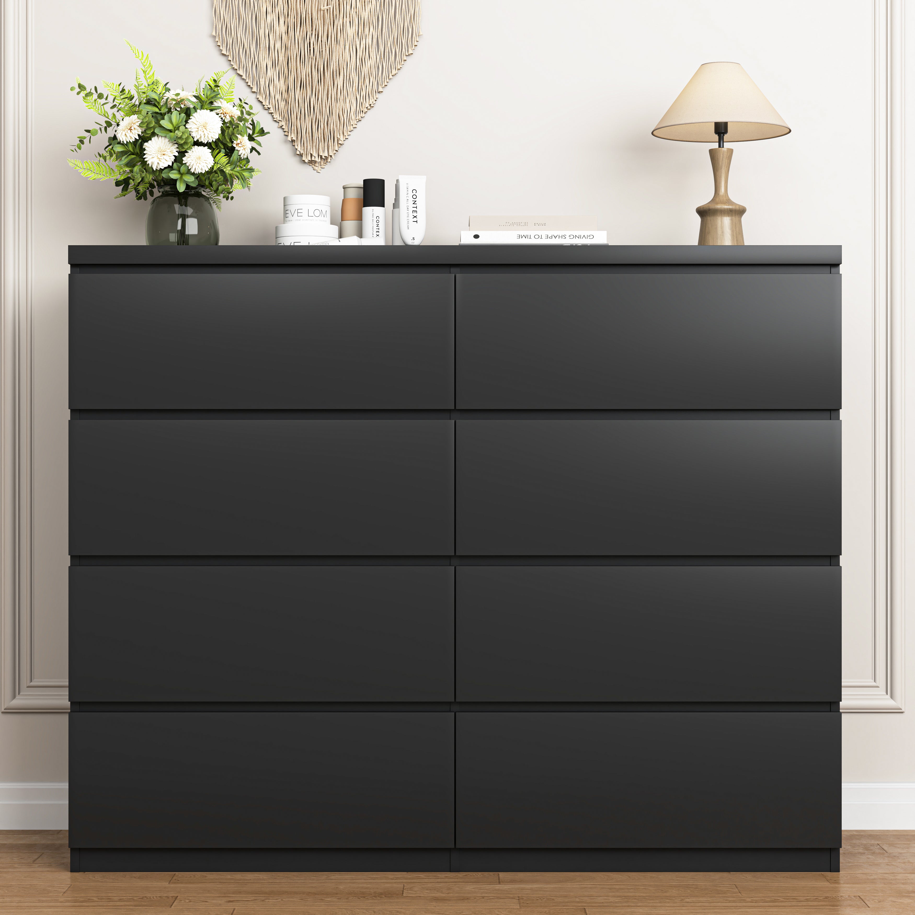 Black wood chest of drawers, drawer handle close-up