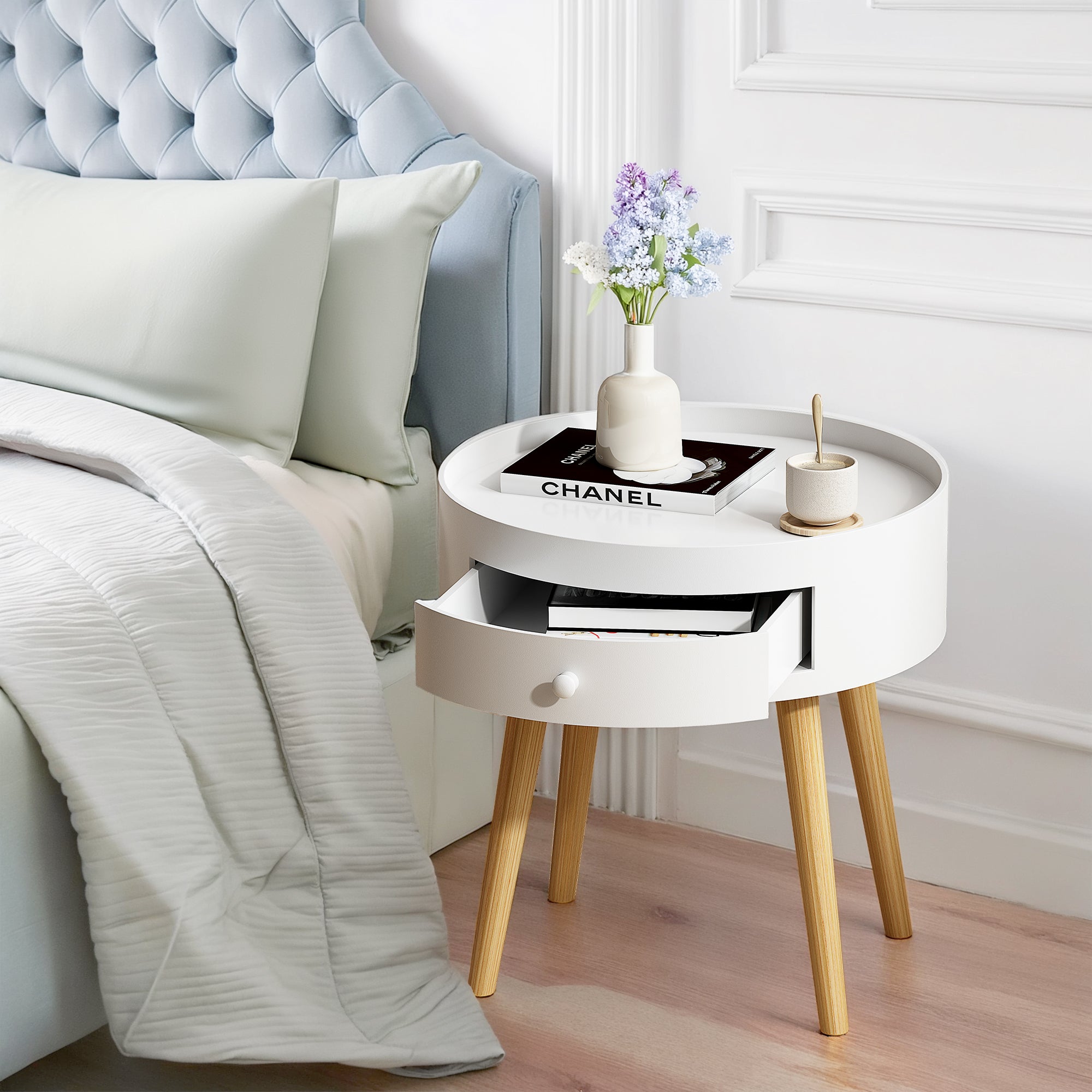 White nightstand with oak legs and storage drawer, front view
