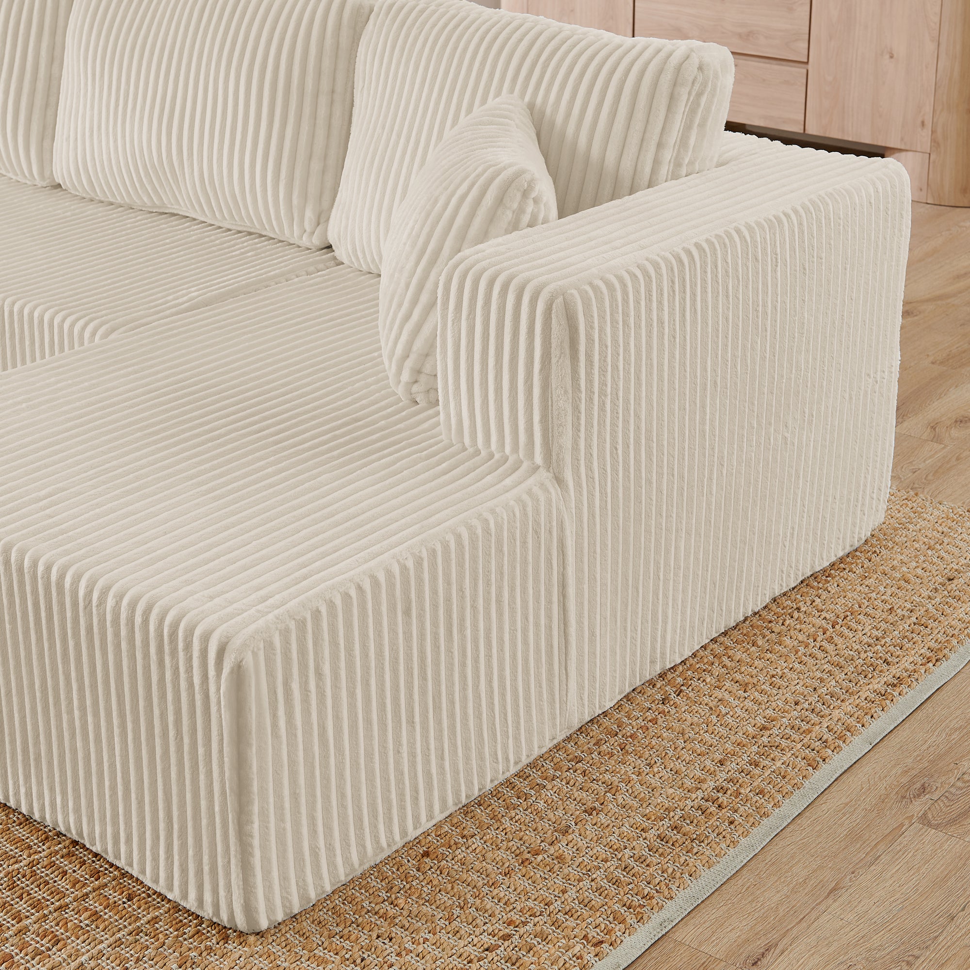 Beige corduroy modular sofa sections, detail view