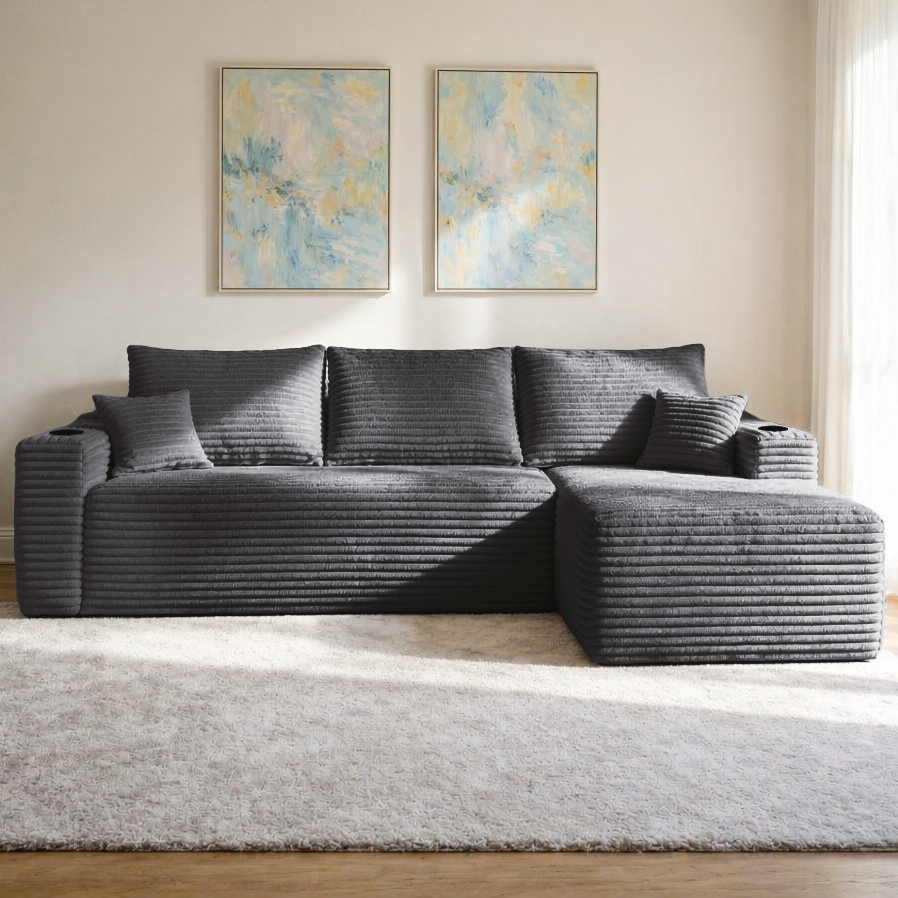 Grey plush sectional sofa with L-shape chaise, angled view