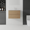 24 inch floating bathroom vanity with oak finish and ceramic sink, front view