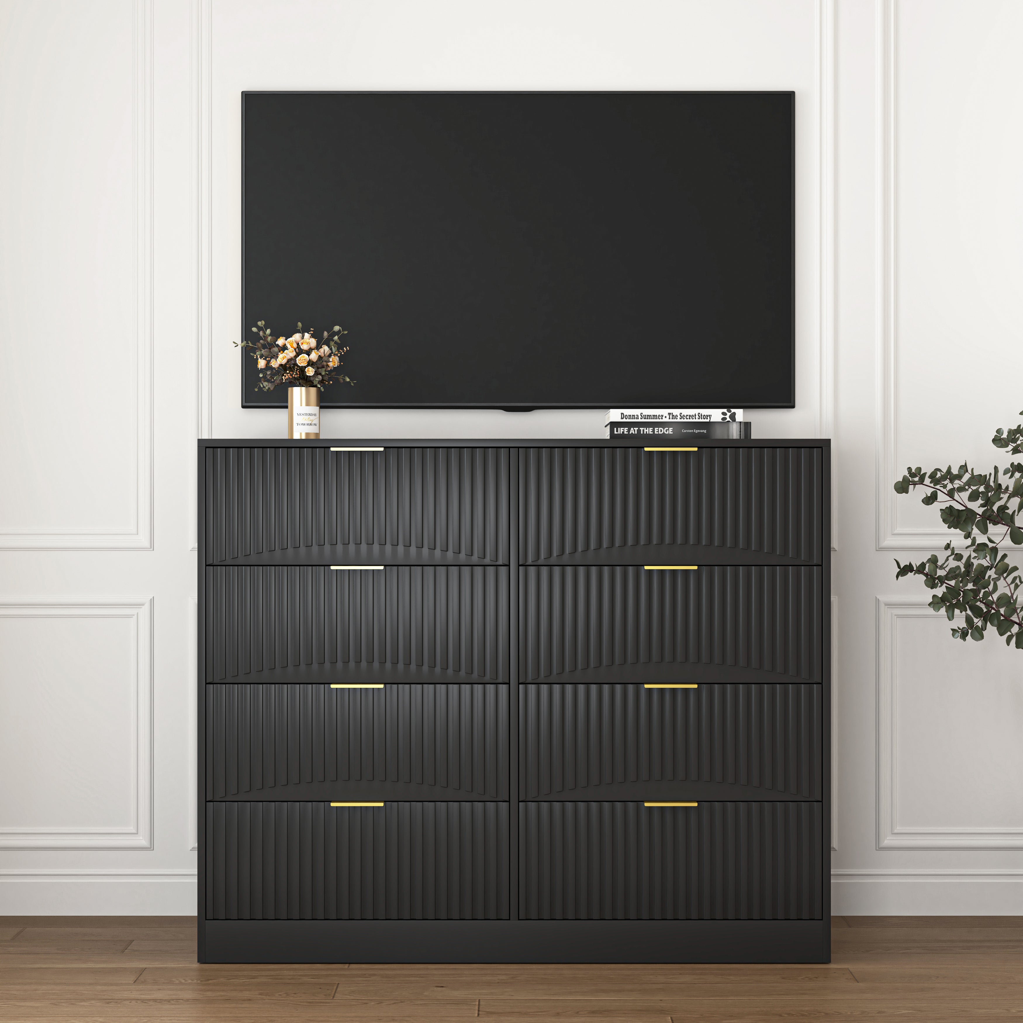 Modern black 8-drawer dresser with gold handles, drawers open showing storage